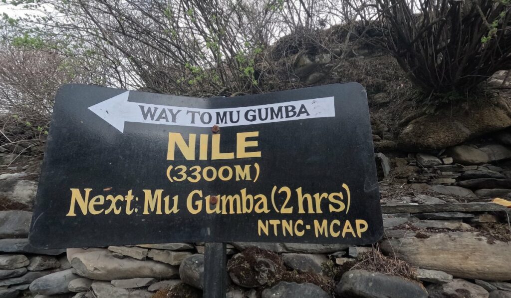 signpost in Nile village indicating the route to Mu Gumba