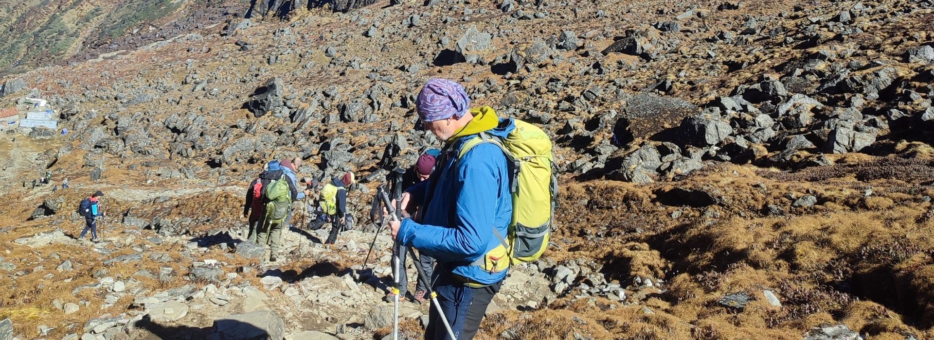 Hiker walks rocky path toward icy EBC peaks