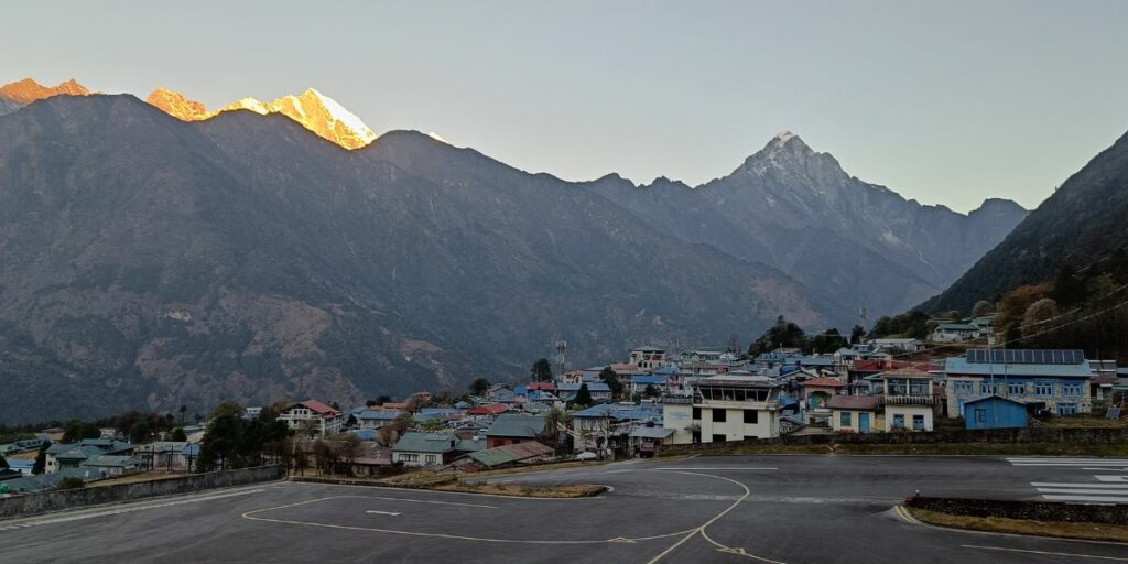 Lukla Airport runway with mountain backdrop at sunrise
