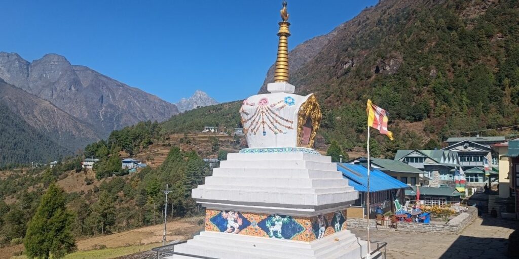 Namche’s monastery stupa with forested hills