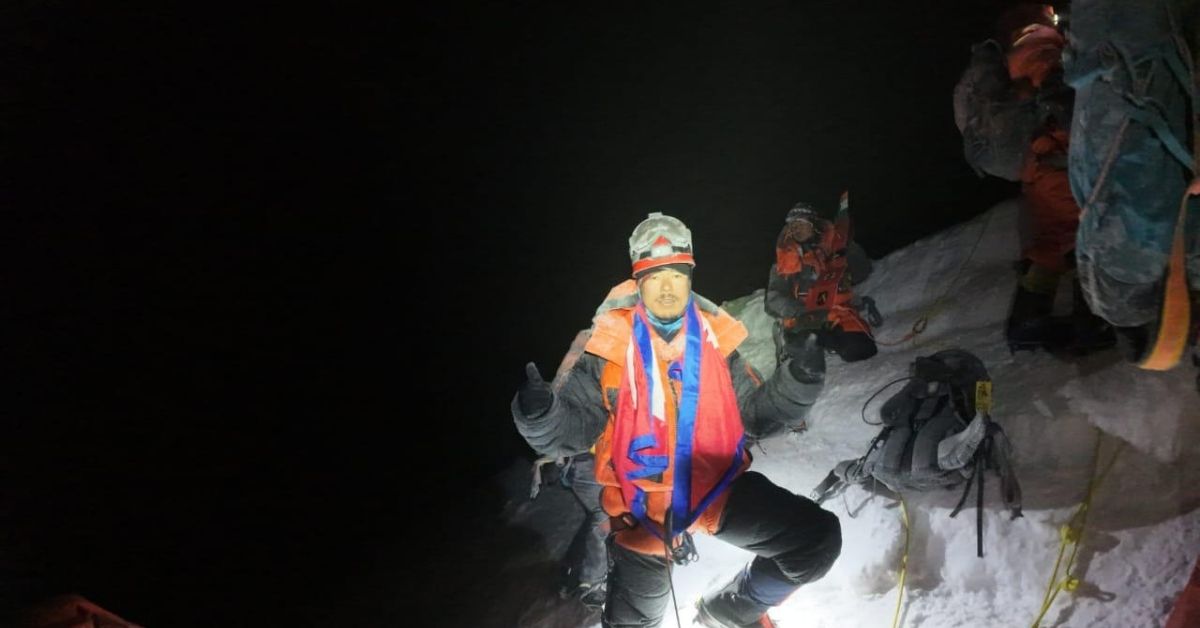 Everest summit team climbing in dark with headlamps