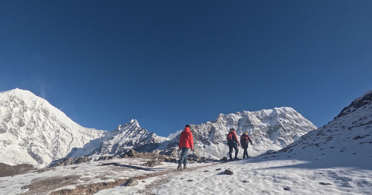 Group walking toward snow-covered Langtang peaks