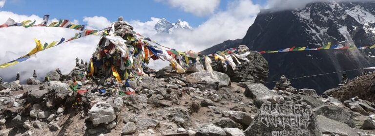 Prayer flags and mani stones at a viewpoint on the EBC