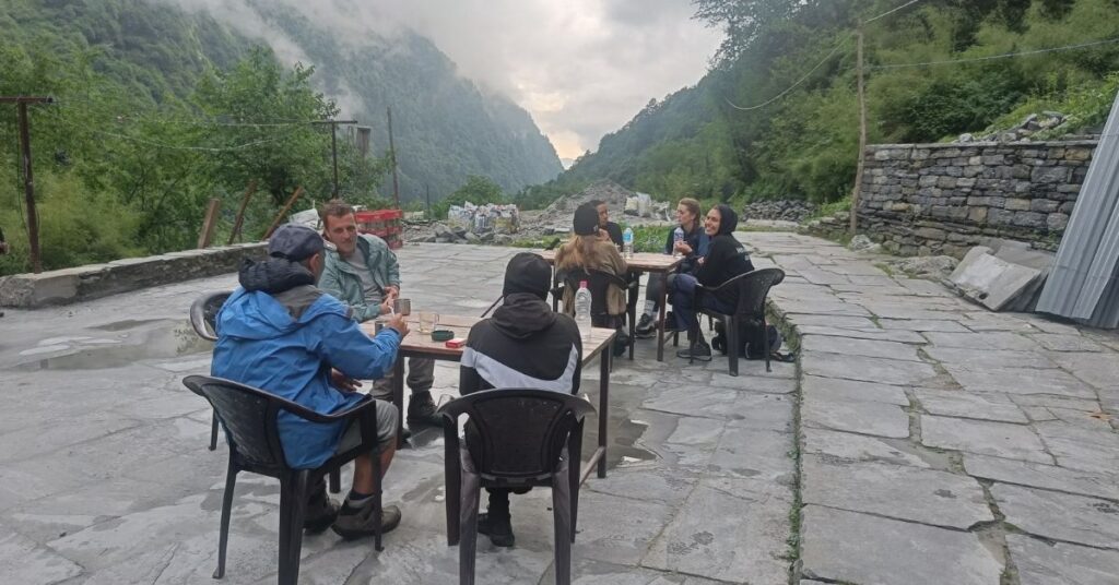 Trekkers resting and hydrating at a mountain village to support acclimatization