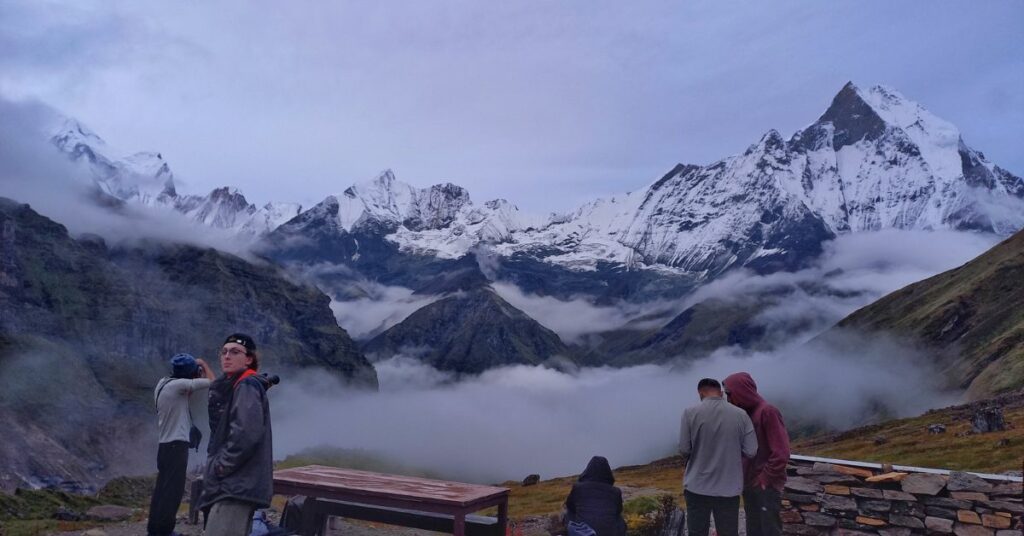 Trekkers resting at wooden bench in ABC area