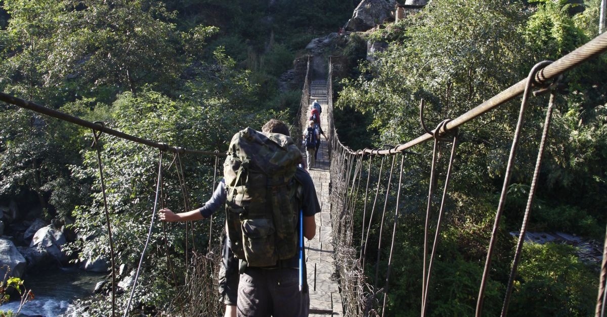 Crossing a high bridge en route Tatopani