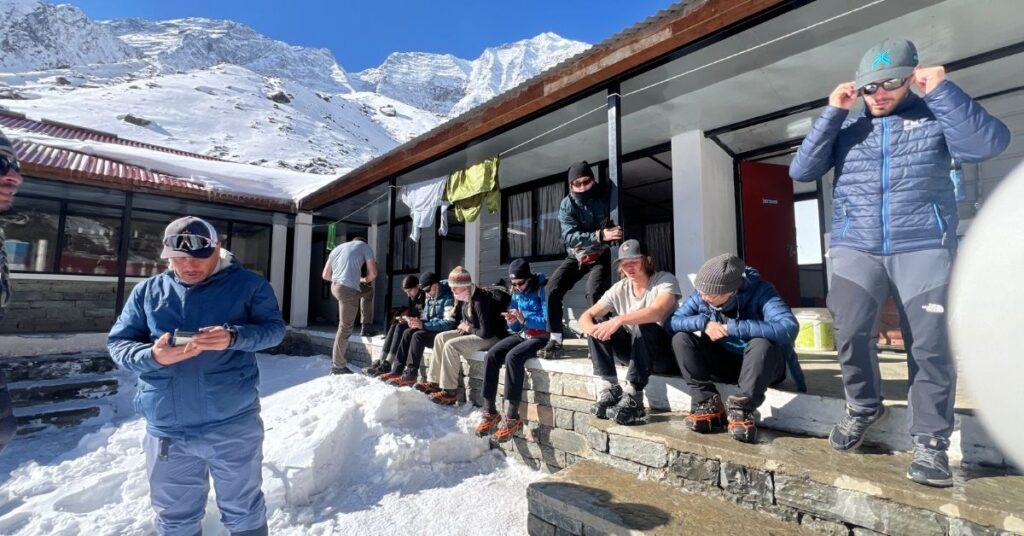 Guided group resting outside tea house on the Annapurna Base Camp trek