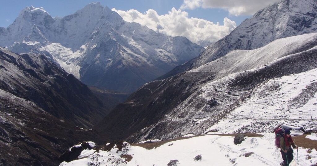 Guided trekker making their way through fresh snow, showcasing how beginners can experience Everest in winter