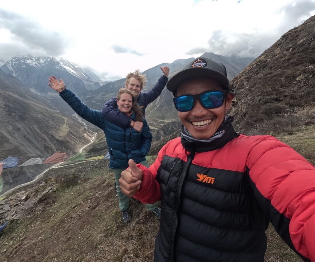 Happy group posing with Mountain Routes guide in the highlands of Manaslu