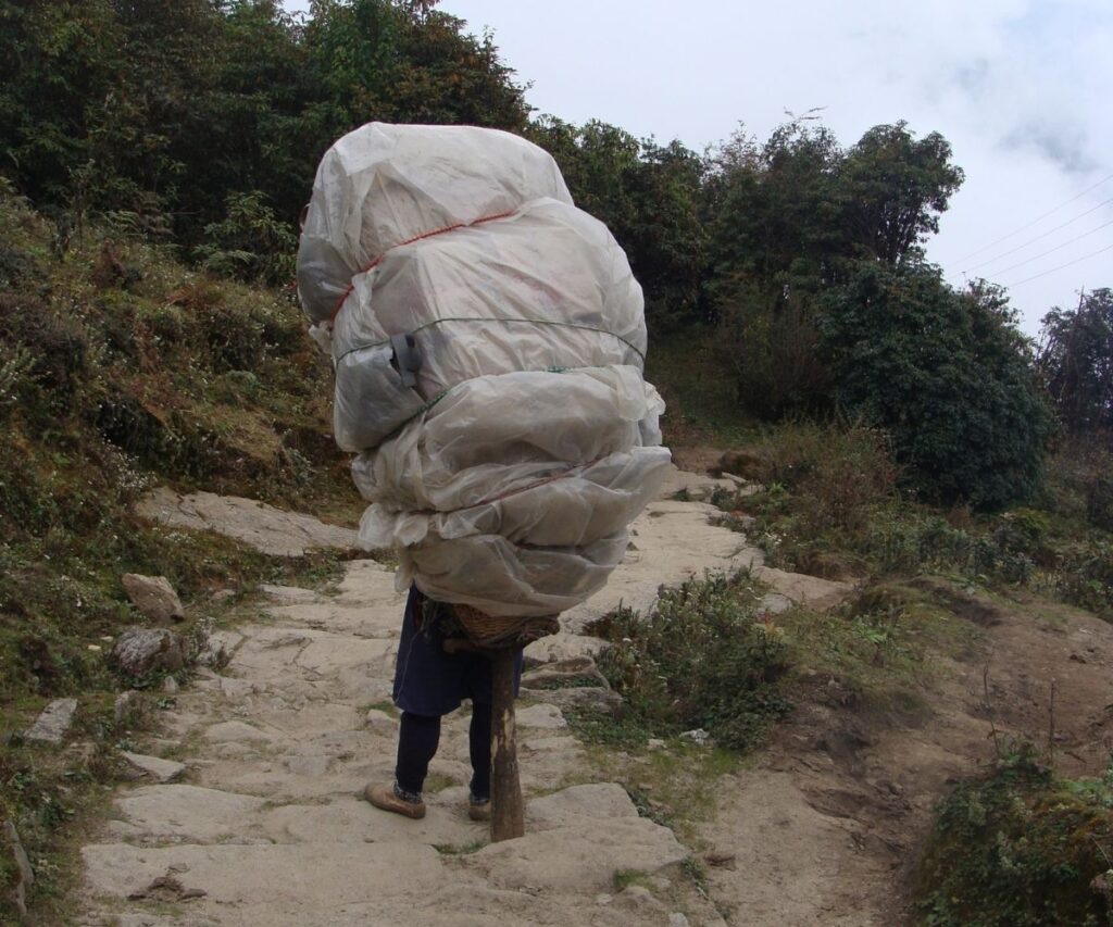 Heavy trekking load carried by local porter