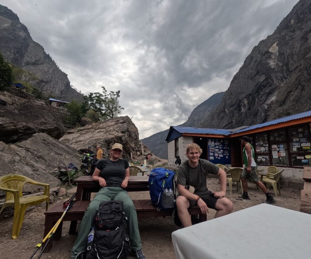 Outdoor stop during Manaslu trek showing hikers with loaded trekking gear and packs