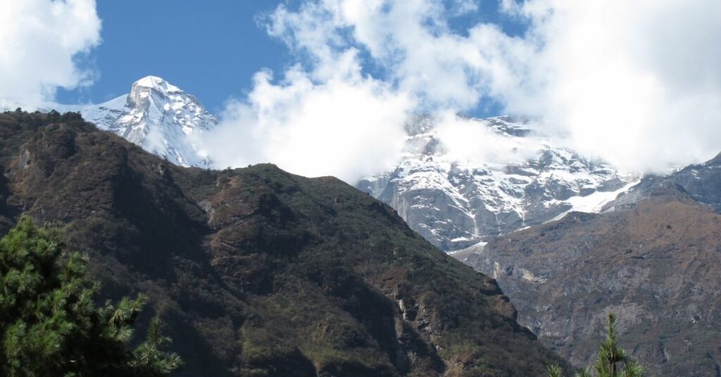 Snow-capped peaks rising above autumn hills on the Everest Base Camp trek