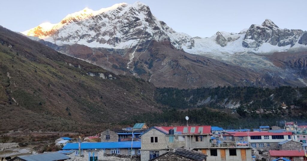 Snowy mountain above Manaslu's circuit Samagaun village at sunrise