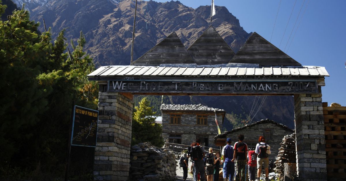 Welcome to Pisang signboard on the Annapurna Circuit trek between Chame and Pisang
