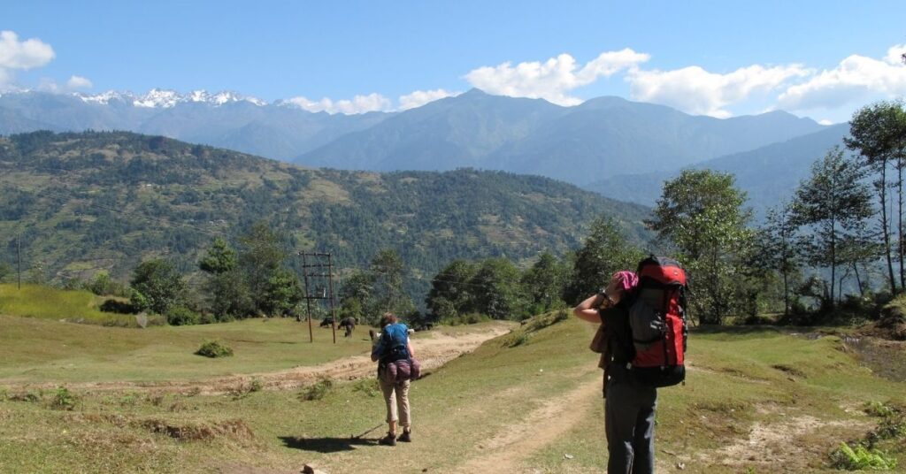 Adventure trekking trail in Nepal with backpackers and stunning mountain backdrop