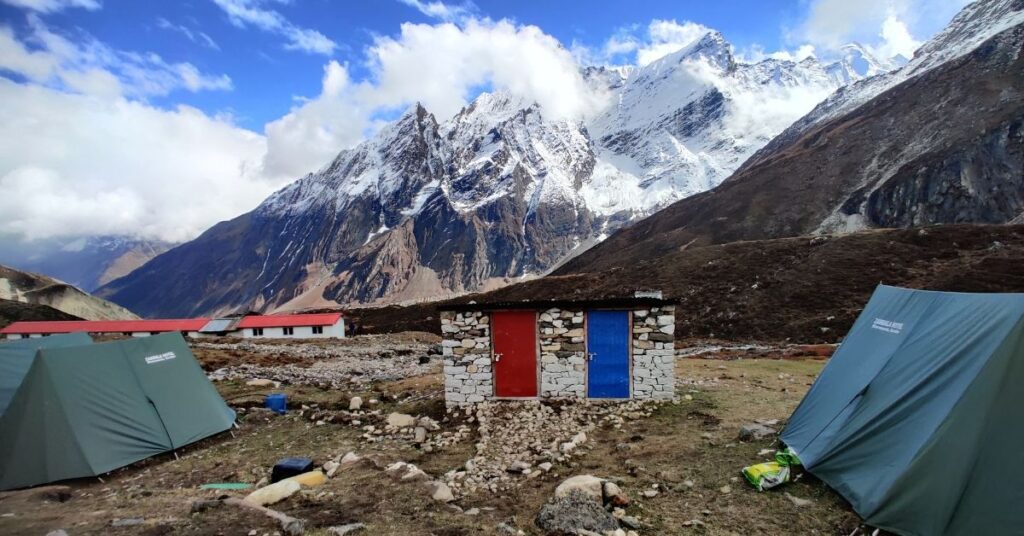 Autumn view of Dharmashala on the Manaslu Circuit Trek with green tents