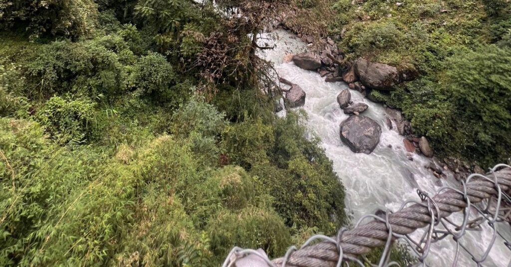 Chhomrong trail with forested valley and river below