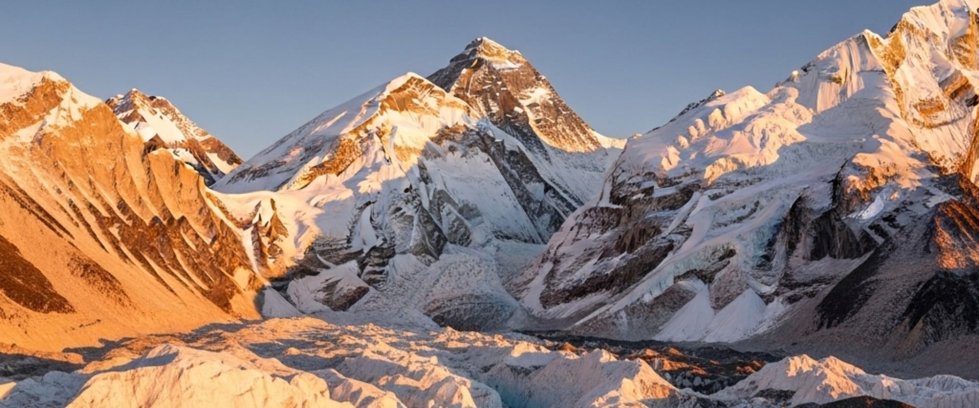 Climbers crossing an ice crevasse on a ladder during Everest expedition