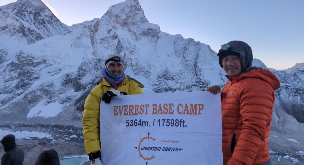 Day 9 of the Everest Base Camp trek_ trekkers celebrating at Everest Base Camp (5,364m) with a banner