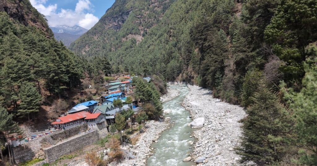 Flowing river and green hills on EBC trek in September