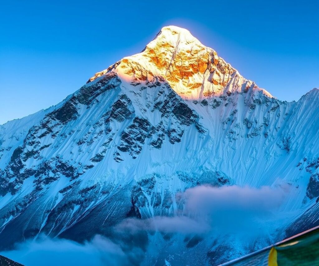Golden sunrise over Mount Everest with prayer flags in view