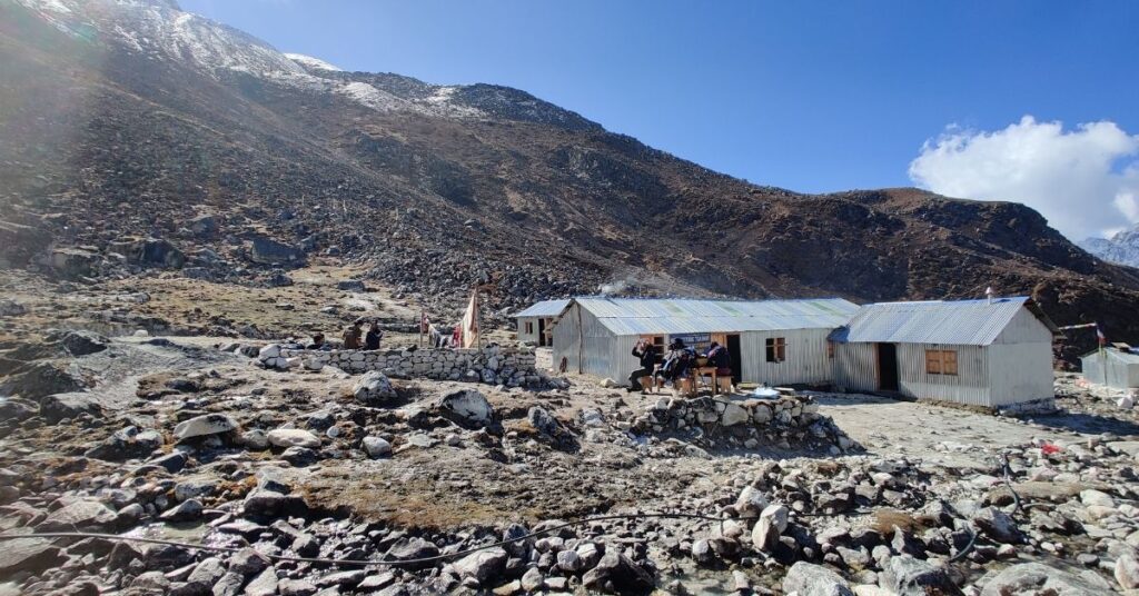 Small teahouses after Larke Pass with travellers resting outside
