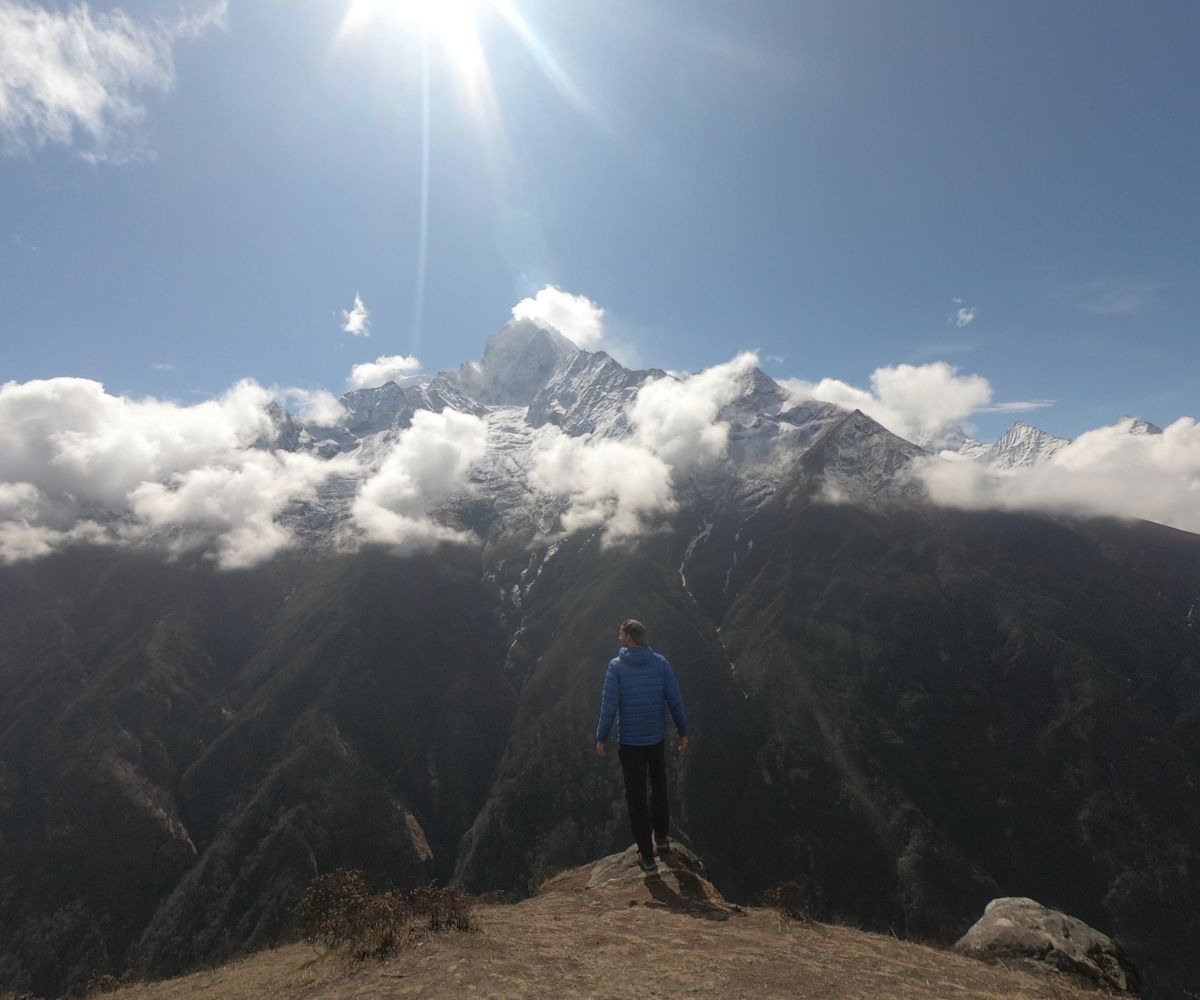 Traveler on EBC trek admiring snowy Himalayan peaks