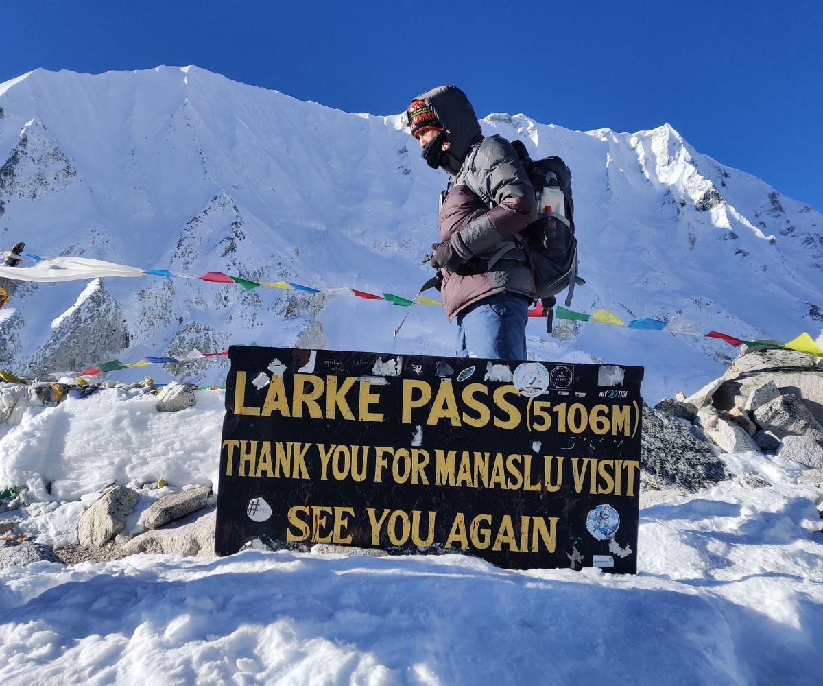 Trekkers reach the snowy high point of Larke Pass at 5,106 m