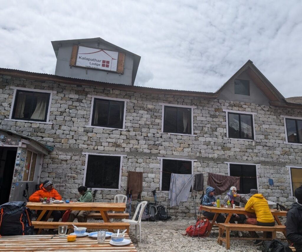 Trekkers resting outside Kalapathar Lodge during Everest Base Camp trek