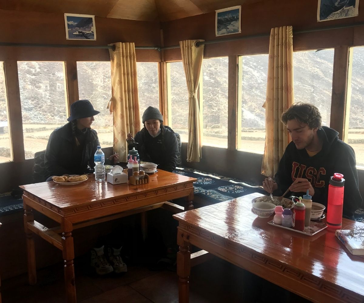 Adventurers enjoying fresh food and water while trekking toward EBC