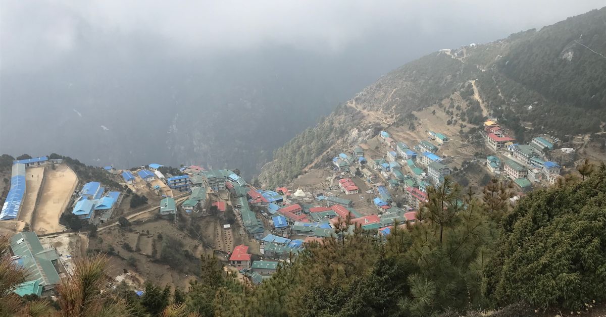 Helicopter landing at a remote helipad in the Everest region