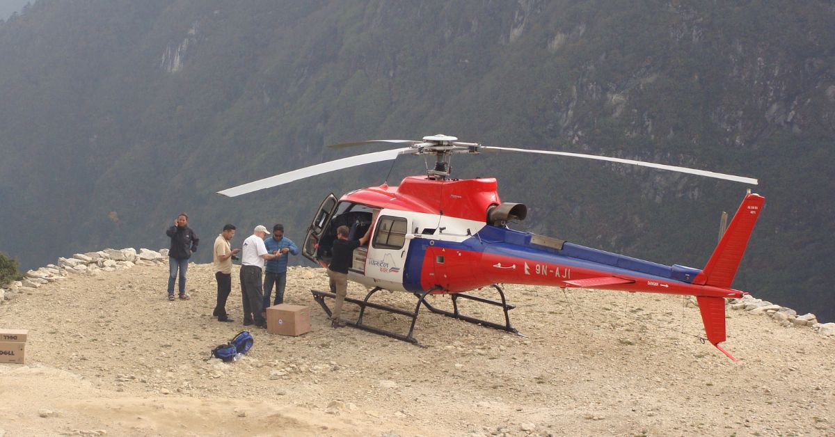 Helicopter landing at a remote helipad in the Everest region