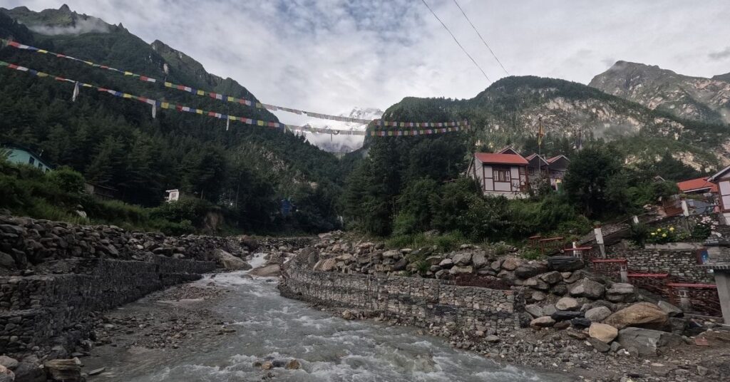 River stream flowing through a scenic valley along a Nepal trek route