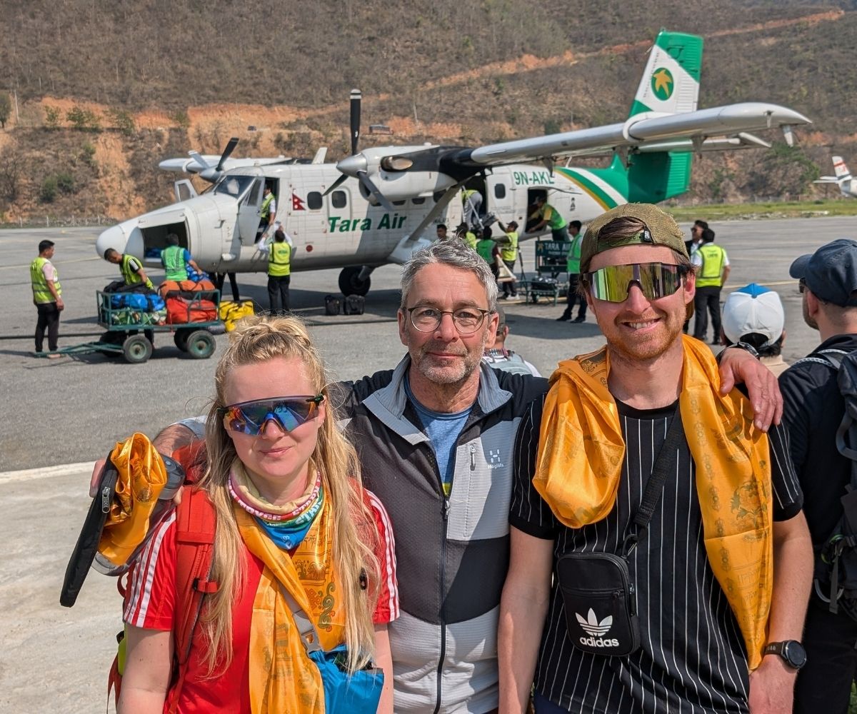 Trekkers standing on Lukla Airport runway after completing the Everest Base Camp Trek