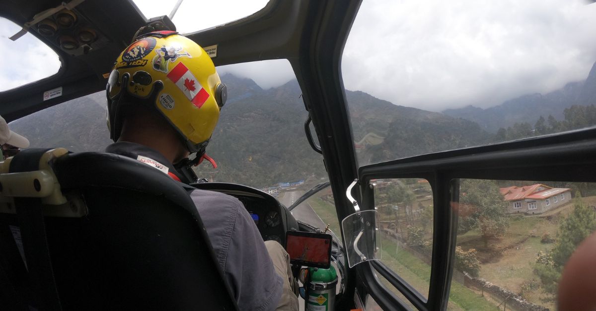 a helicopter over the mountains near Lukla during the EBC trek return flight to Kathmandu