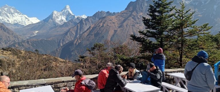 tourist resting during their Nepal hike and planning the upcoming trail