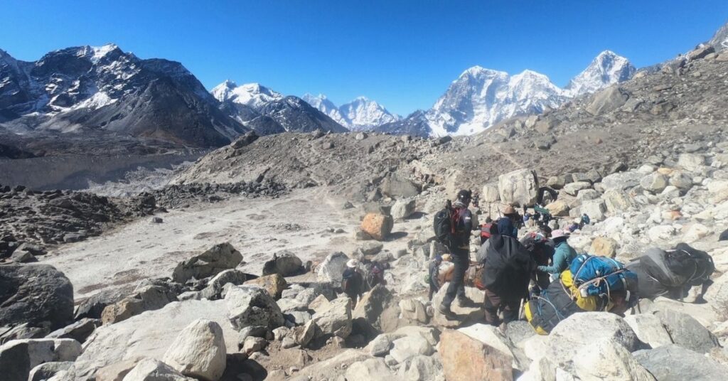 Hikers moving through rough terrain near Everest region