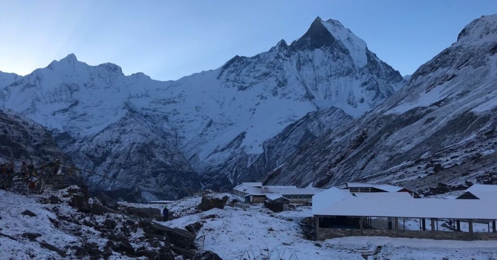 Snowy Annapurna Base Camp with Machapuchare at sunrise