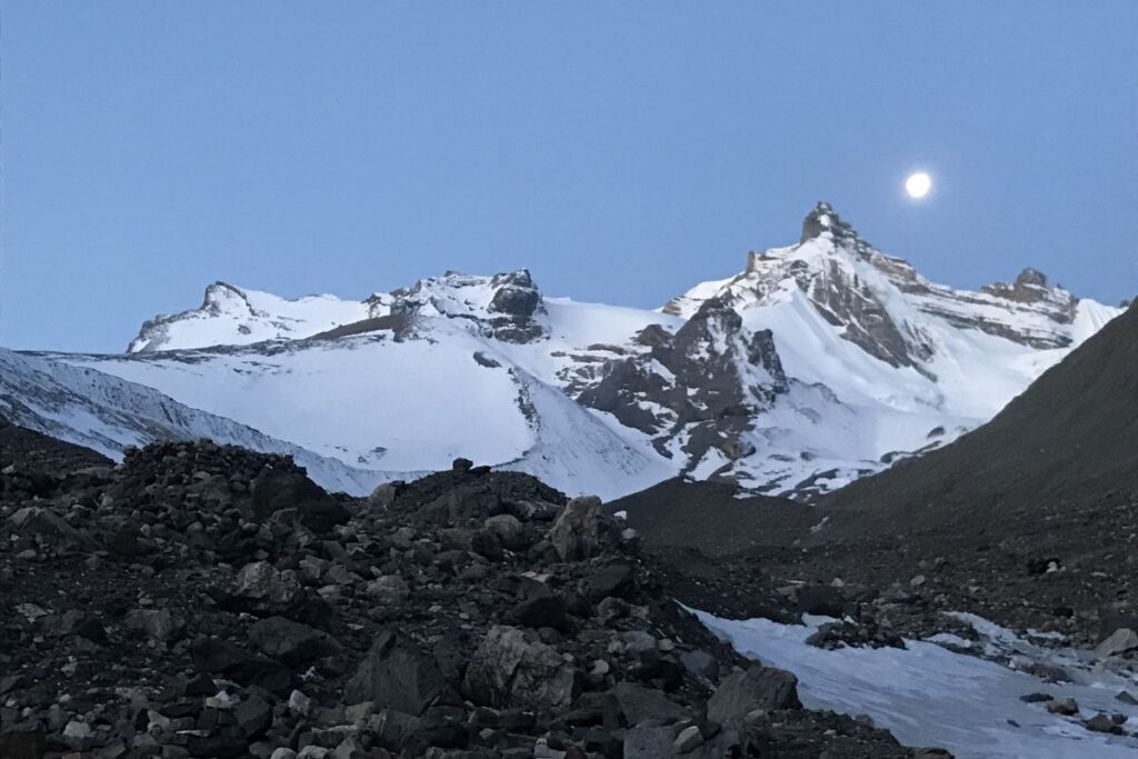 Moonlit snowy peaks above rocky Annapurna trail