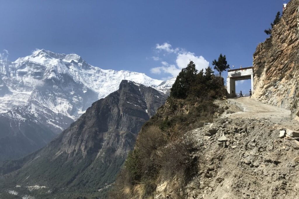 Rocky Annapurna Circuit path beneath towering mountains